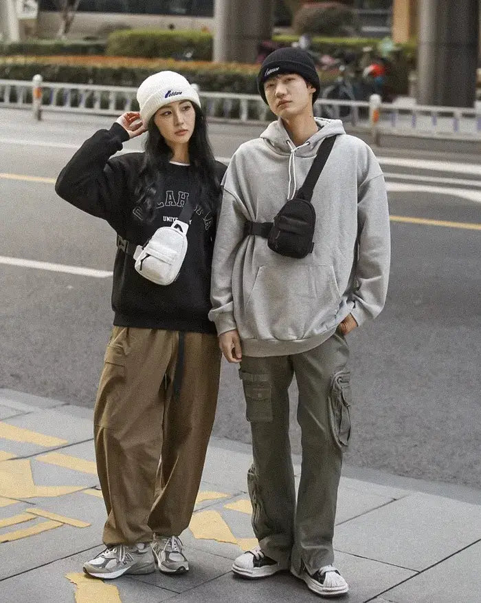 a girl and a man wearing the Streetwear sling bag "Poro"