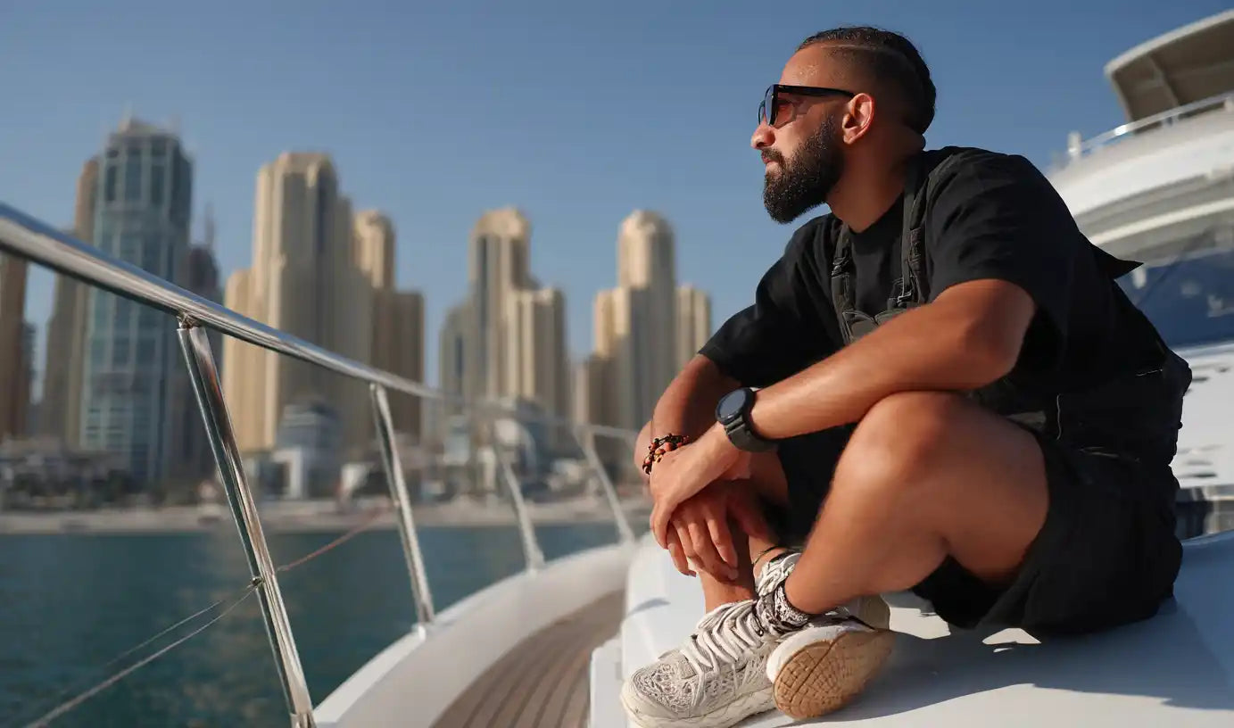 man in techwear outfit on a luxury yatch in dubai