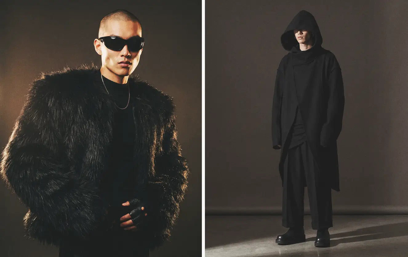 Avant-garde clothing editorial featuring a man in a voluminous black faux fur coat with wrap sunglasses and fingerless leather gloves — paired with a full look of an oversized black hooded asymmetric longline coat worn over wide-leg dark trousers