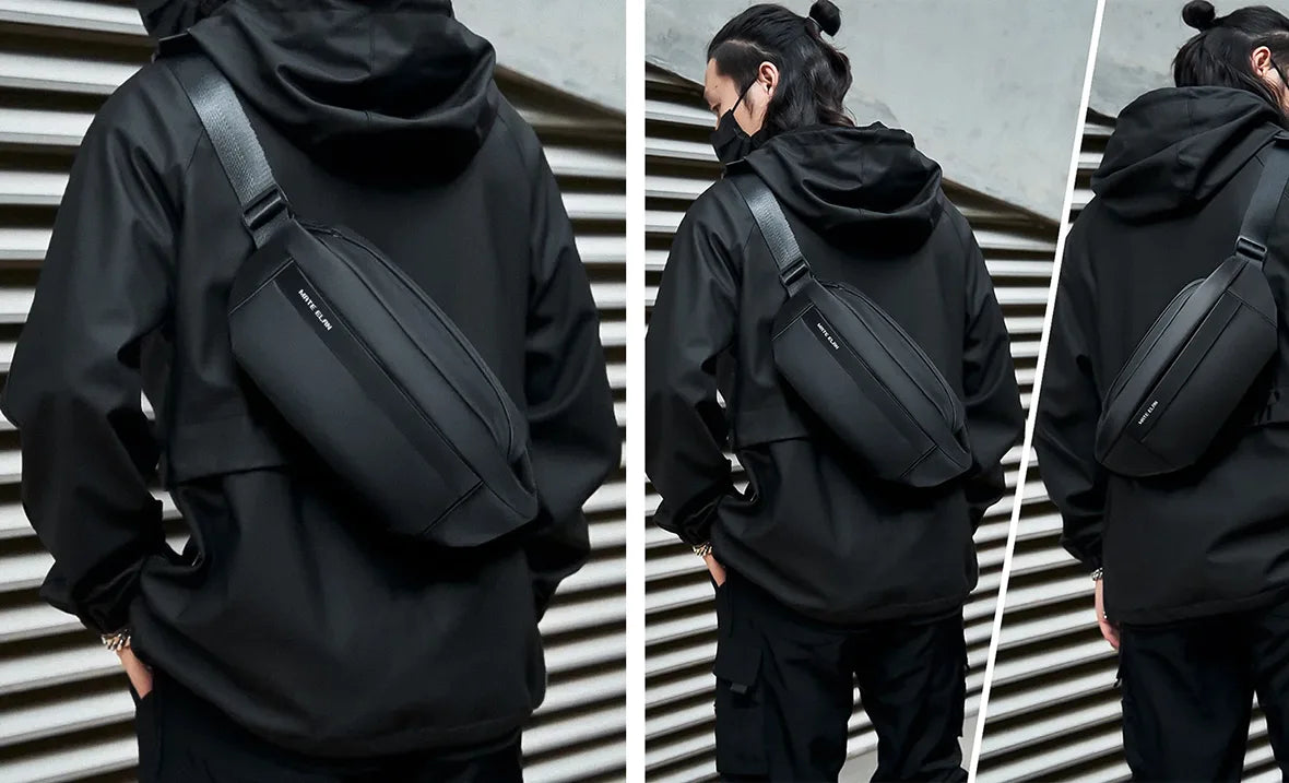 man in all black techwear outfit with cross body bag