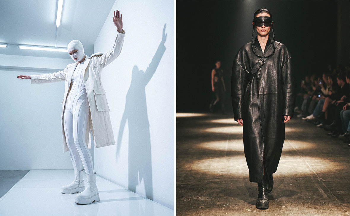 Two runway models presenting futuristic fashion; one in an all-white bodysuit and trench coat with head wraps, and another in a long black leather coat and avant-garde eyewear.