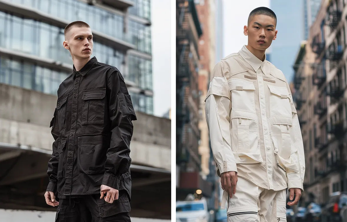 Two men in modern urban techwear; the left styled in a black utility long sleeve shirt with buttoned pockets, and the right dressed in a sleek white design.