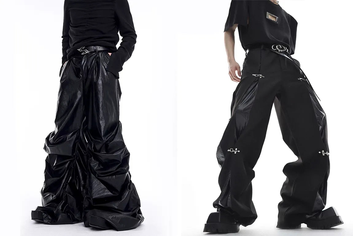 A pair of models showcasing avant-garde opium pants, with one in a highly textured, draped black leather style and the other in wide-leg pants with metallic details.