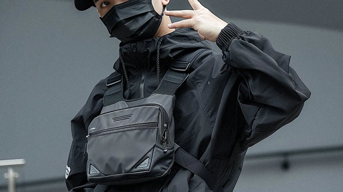 man in techwear outfit wearing a chest bag