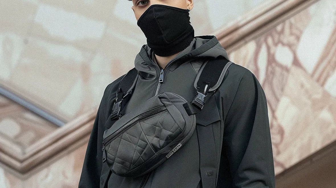 man in techwear outfit wearing a chest bag