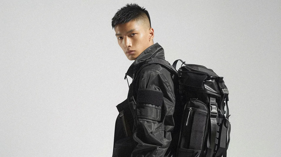 asian man in techwear outfit wearing a techwear backpack