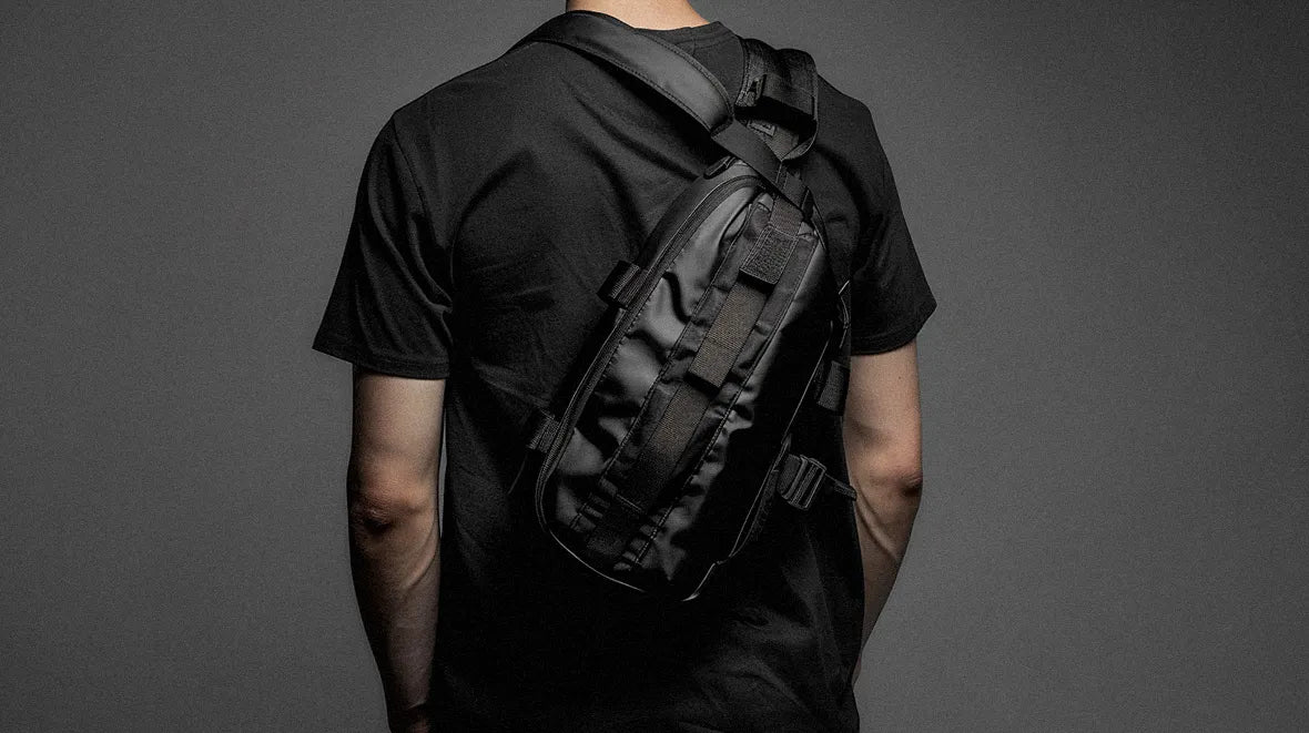 man in techwear outfit wearing a techwear sling bag