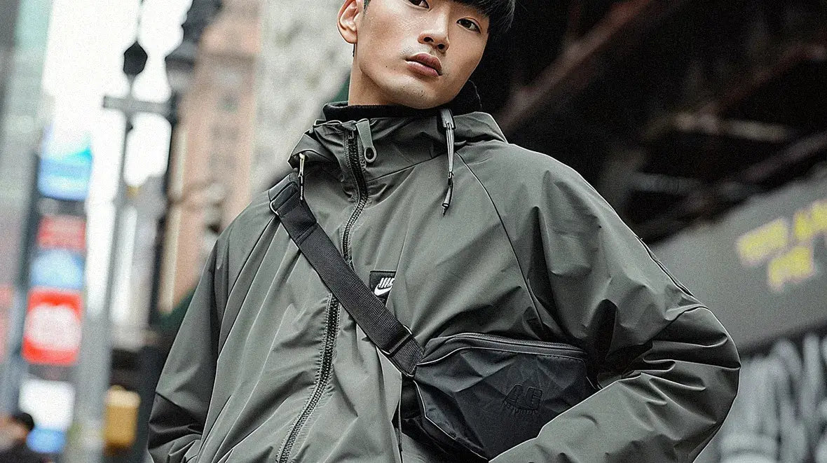 an asian man with techwear jacket wearing a techwear fanny pack