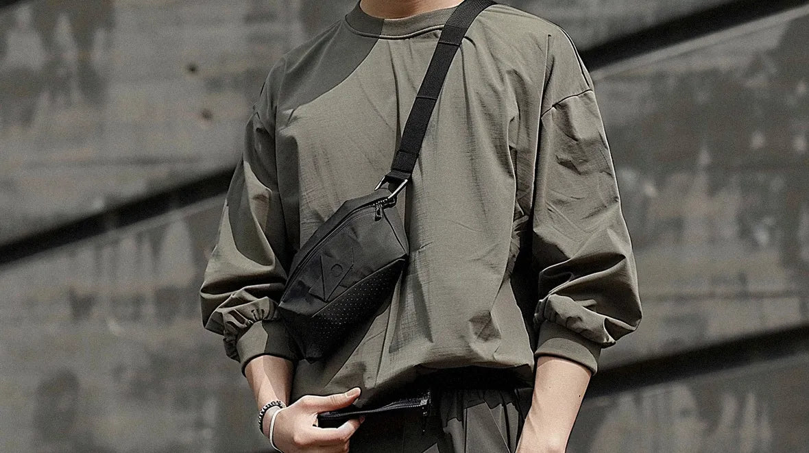 a man with khaki shirt wearing a techwear fanny pack