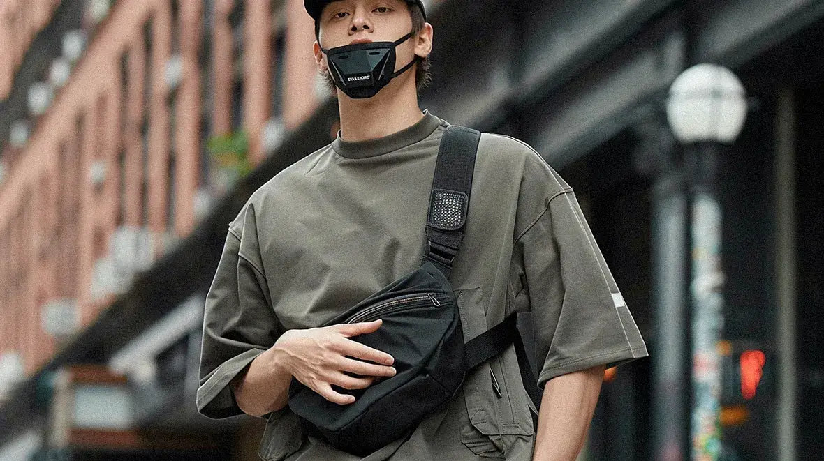 an asian man with a cap wearing a techwear fanny pack