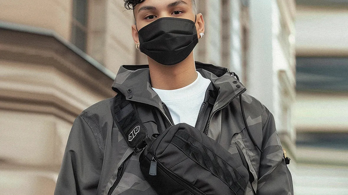 a man wearing a mask and a techwear fanny pack