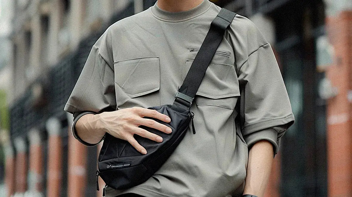 a man wearing a techwear fanny pack with a grey shirt