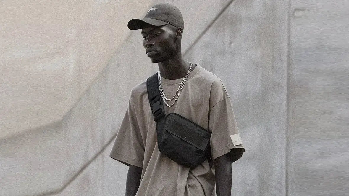 a black man wearing a techwear fanny pack