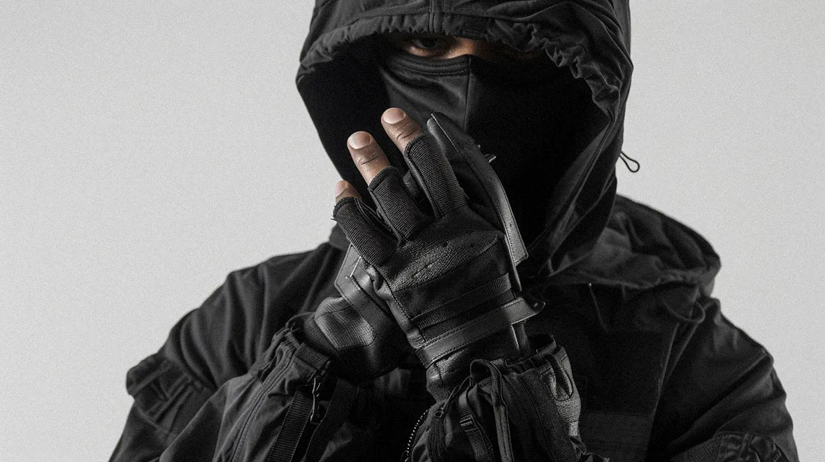 a man wearing fingerless techwear gloves