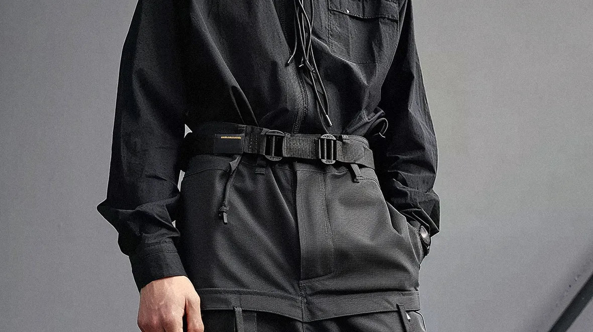 a man in a black outfit wearing a tactical belt