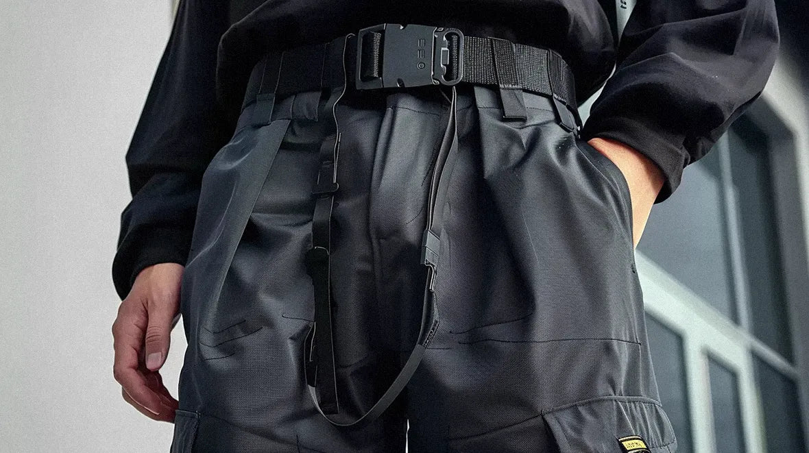 a man with the hand in the pocket with a black tactical Techwear Belt