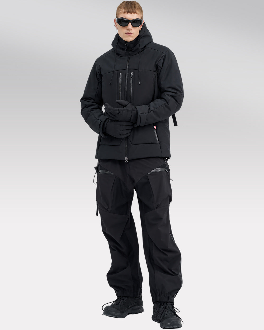 Waterproof Puffer Jacket Hinohe in black - hood-down styling with hands together