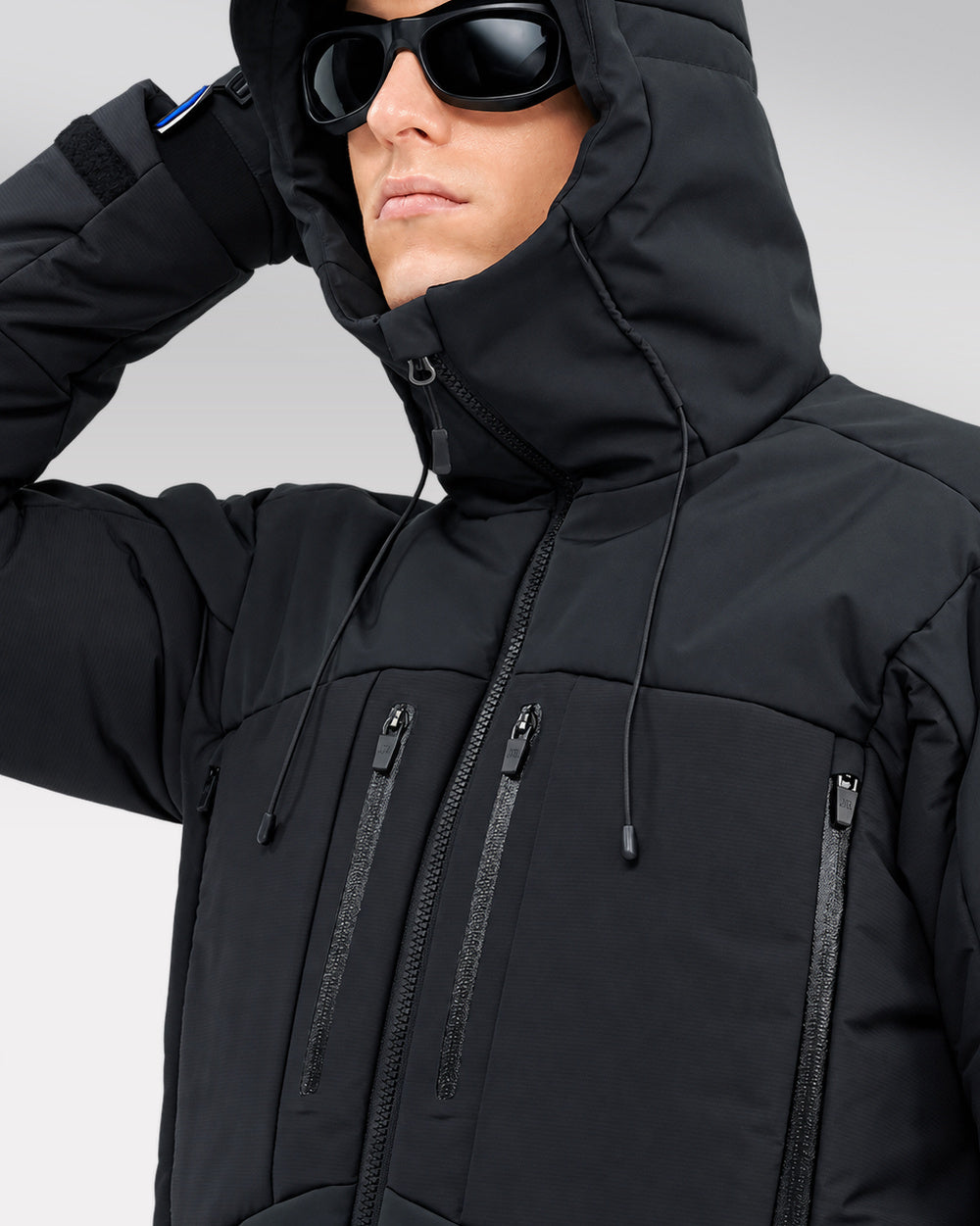 Waterproof Puffer Jacket Hinohe in black - hood and chest pocket close-up