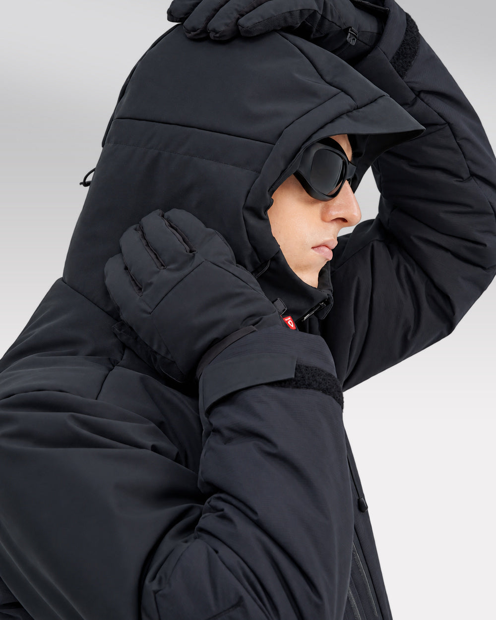 Waterproof Puffer Jacket Hinohe in black - hood adjustment close-up